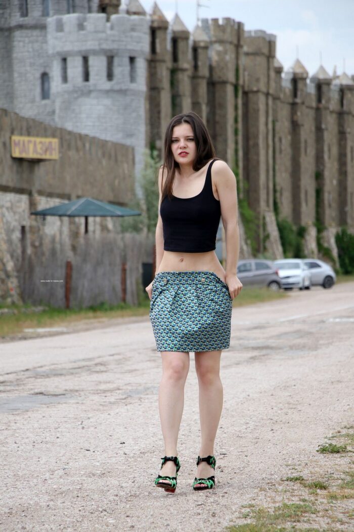 Young girl Vika K takes off her skirt and top on the road