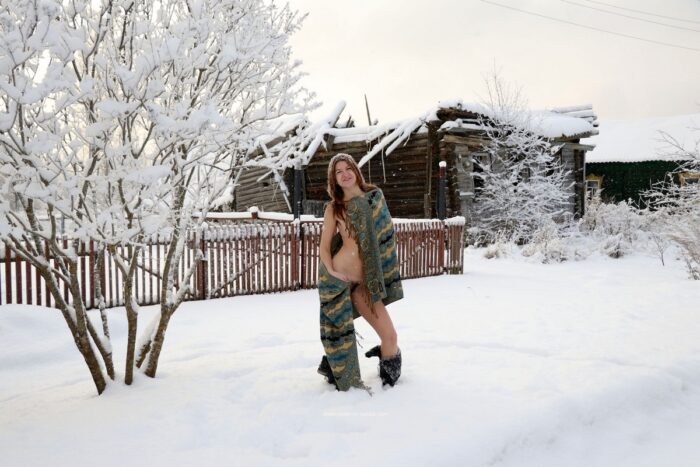 Young red-haired girl Atisha with a hairy cunt walks through the snow-covered village