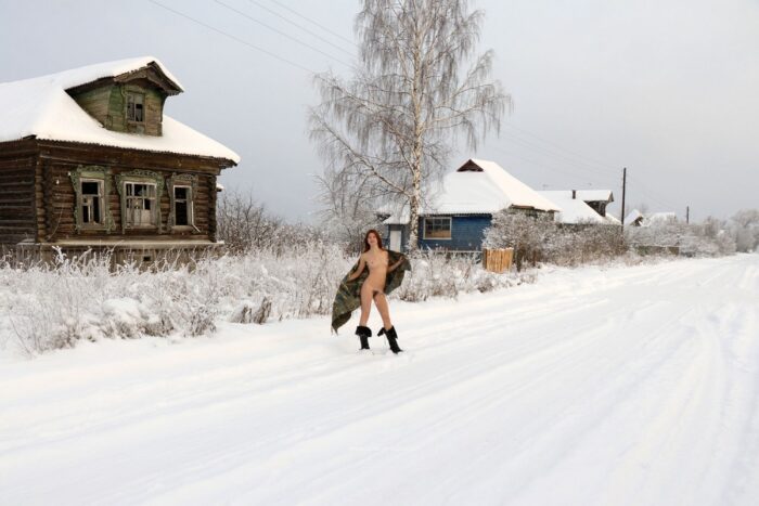 Young red-haired girl Atisha with a hairy cunt walks through the snow-covered village