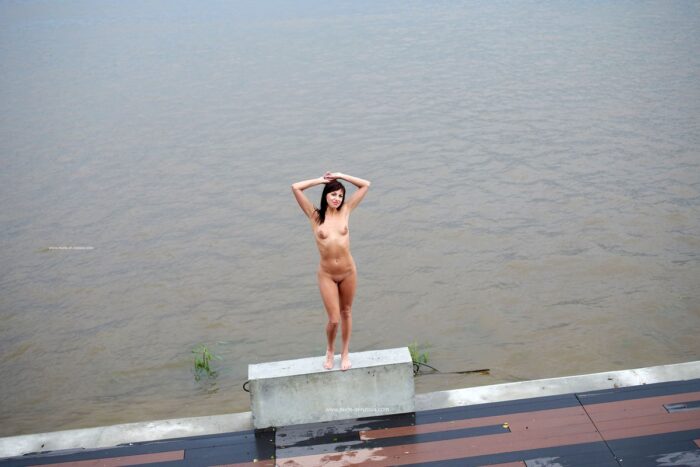Lovely milf Naden walks naked at embankment