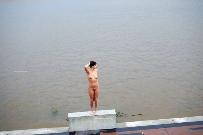 Lovely milf Naden walks naked at embankment