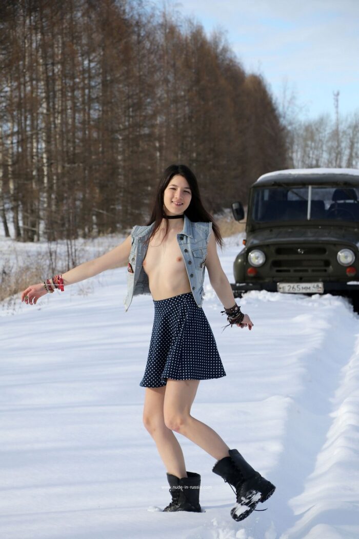 Naked brunette Katja P in boots on a snowy road