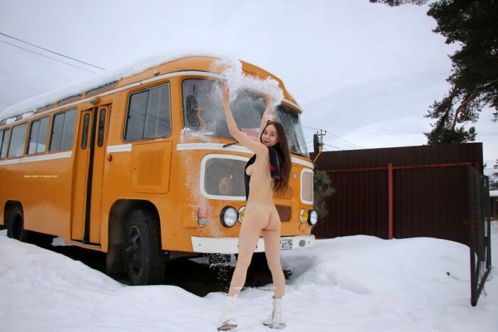 Petite teen Natali posing at old bus