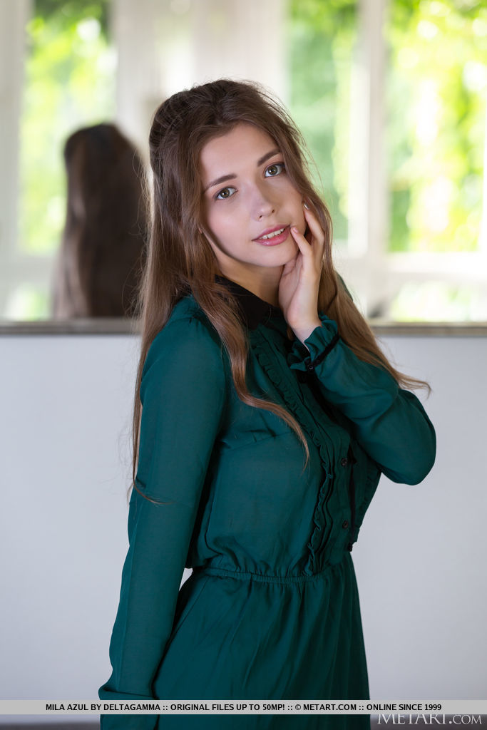 Mila Azul enticingly slip out off her green dress and uncovers her huge heavy knockers and smooth cunt on the couch.