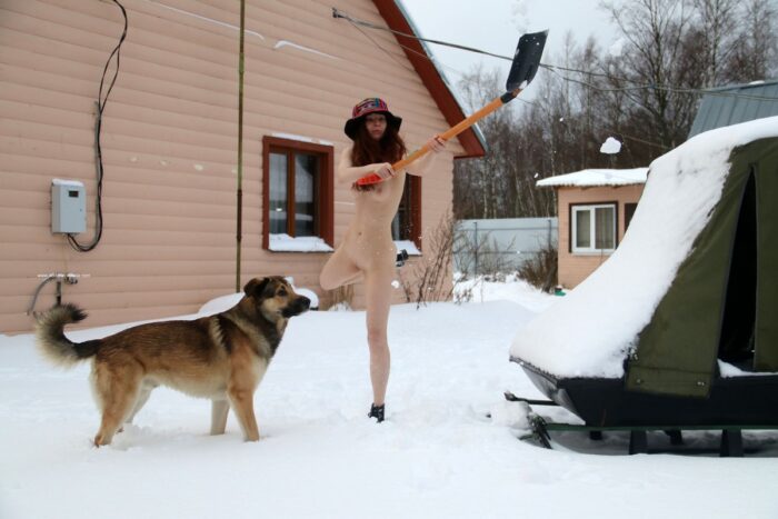 Young girl Alina S without clothes throws snow