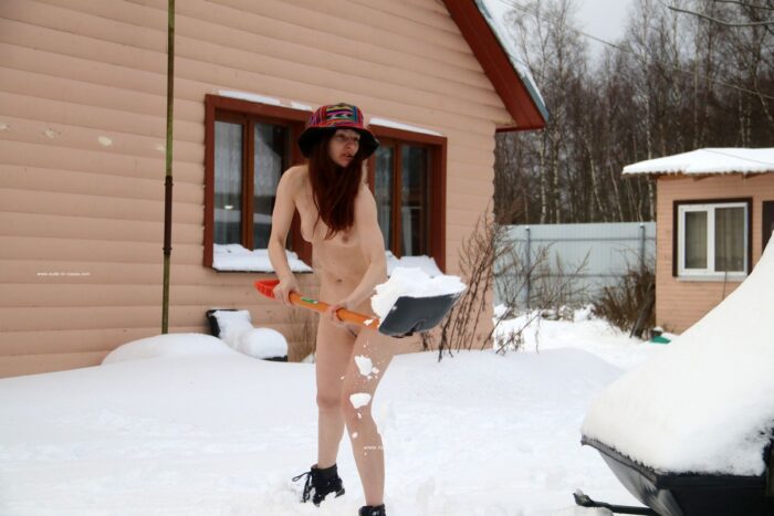 Young girl Alina S without clothes throws snow
