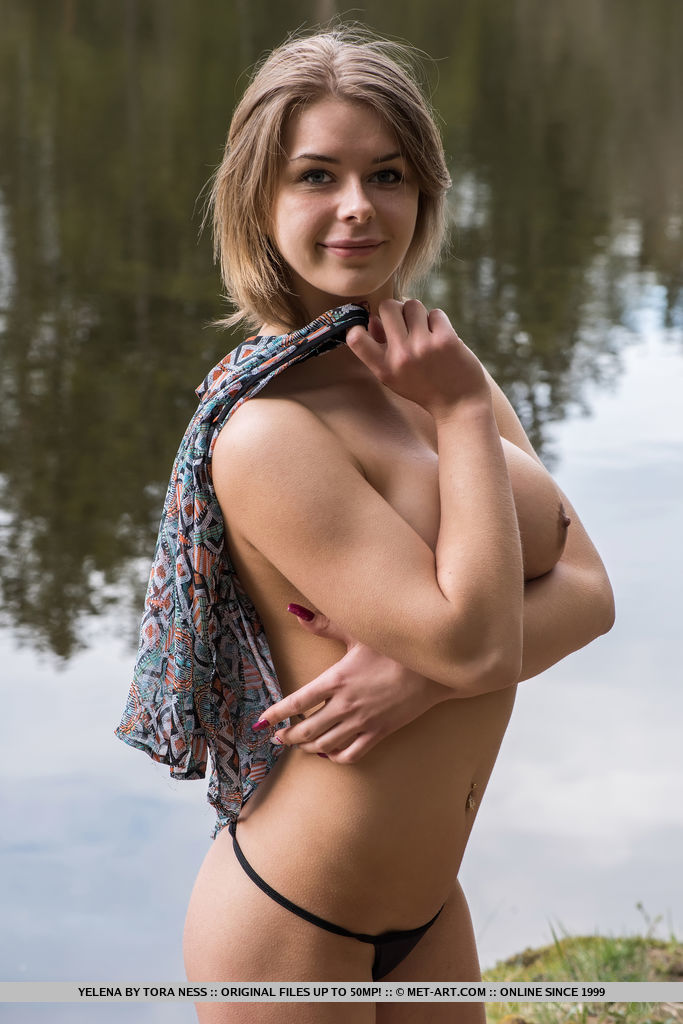 Yelena strips by the river baring her curvy hips and big tits.