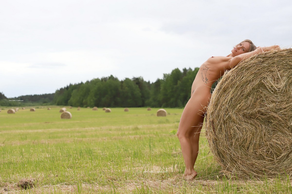 Girl Mari with a tattoo posing on the hay