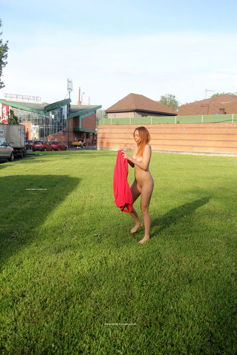 Red-haired young girl Lera S quickly undresses near the Moscow ring road