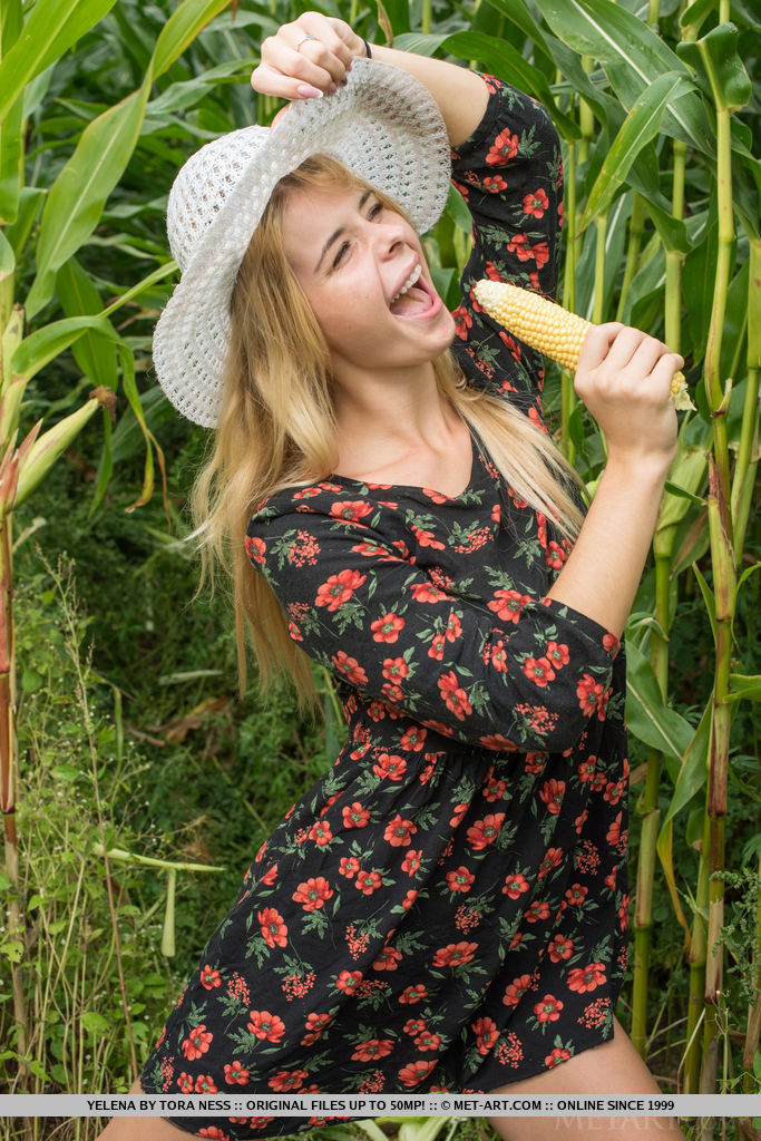 Yelena playfully poses in the cornfield baring her meaty pussy.