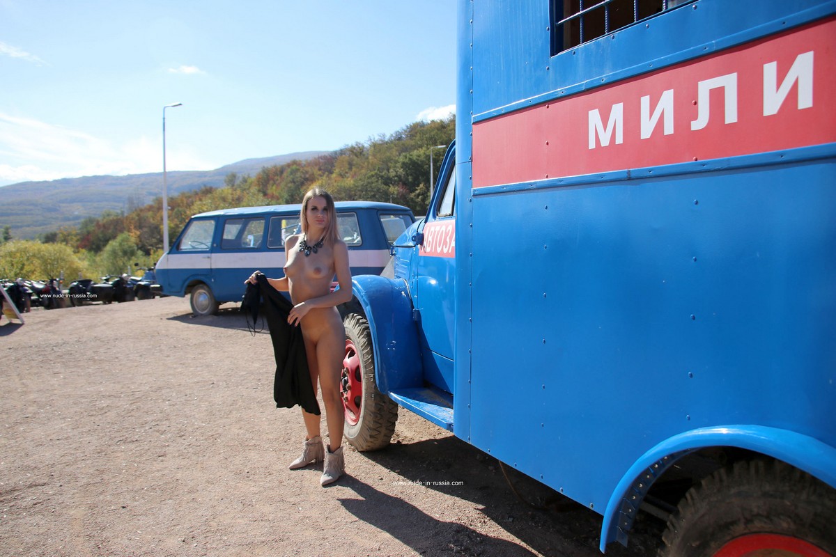 Beautiful russian girl Vlada undresses in a small museum of old cars