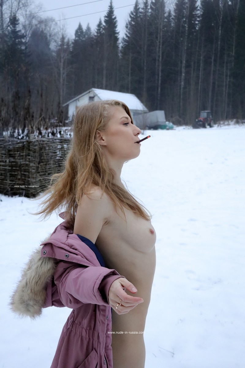Gorgeous blonde Eva Gold in white socks smokes outdoors in winter