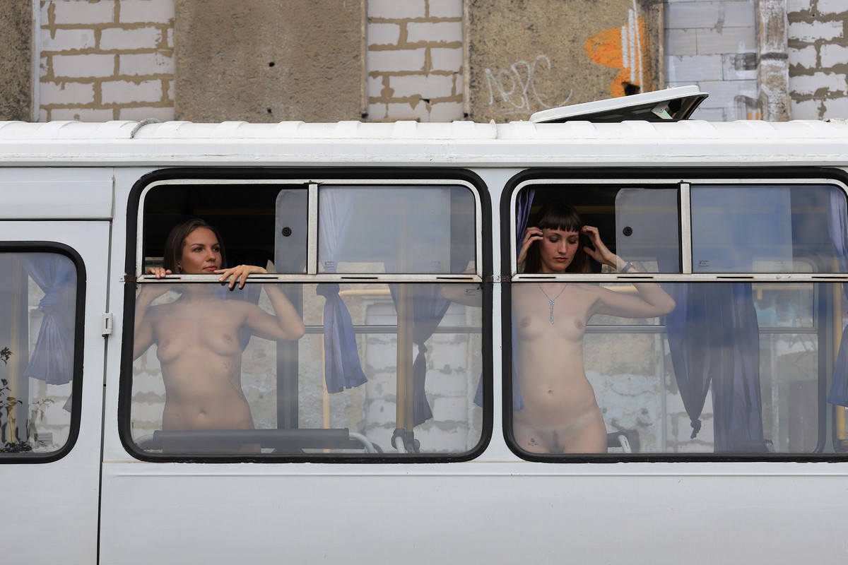 Two girls undress in a country bus