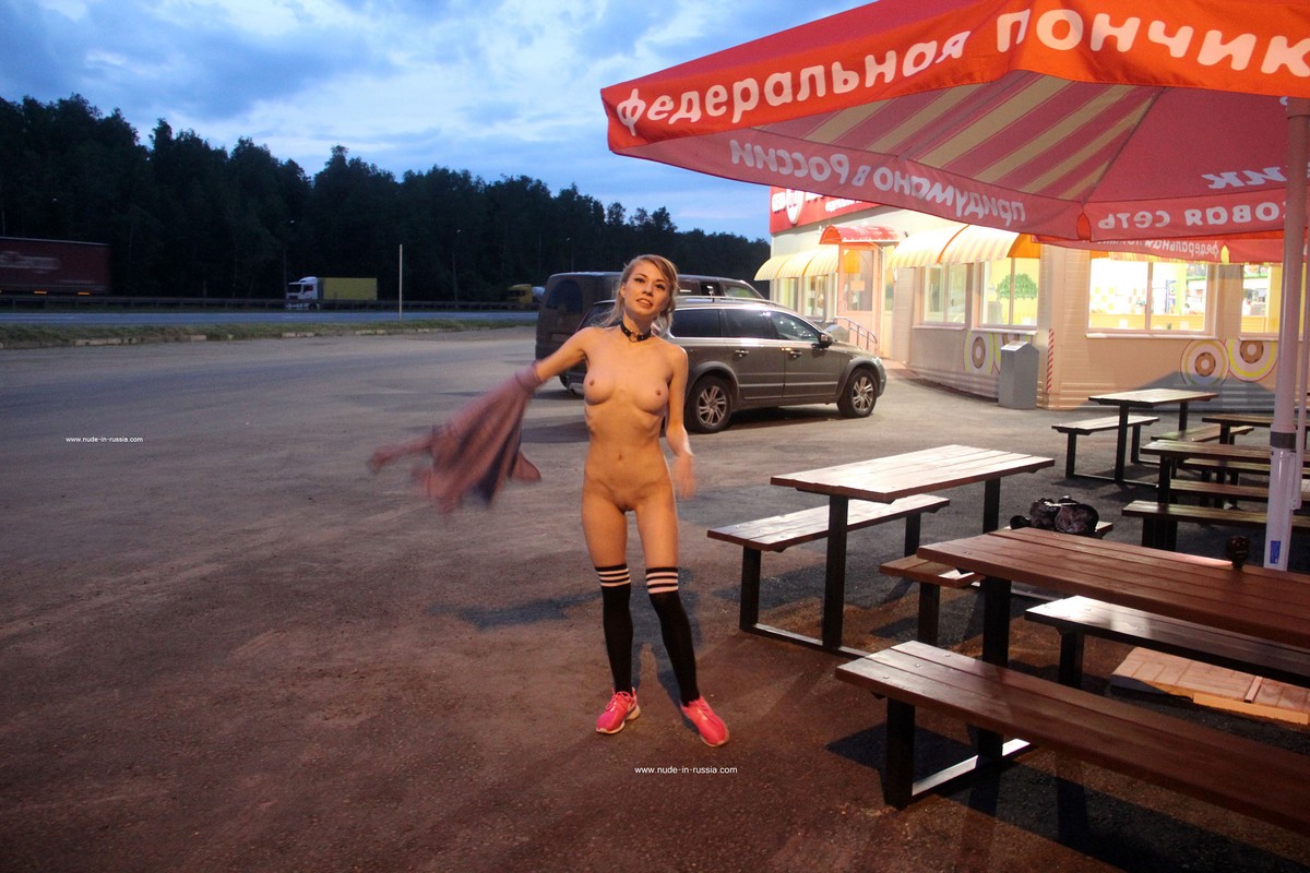 Gorgeous Russian girl Eva Gold undresses in the rest area near the highway