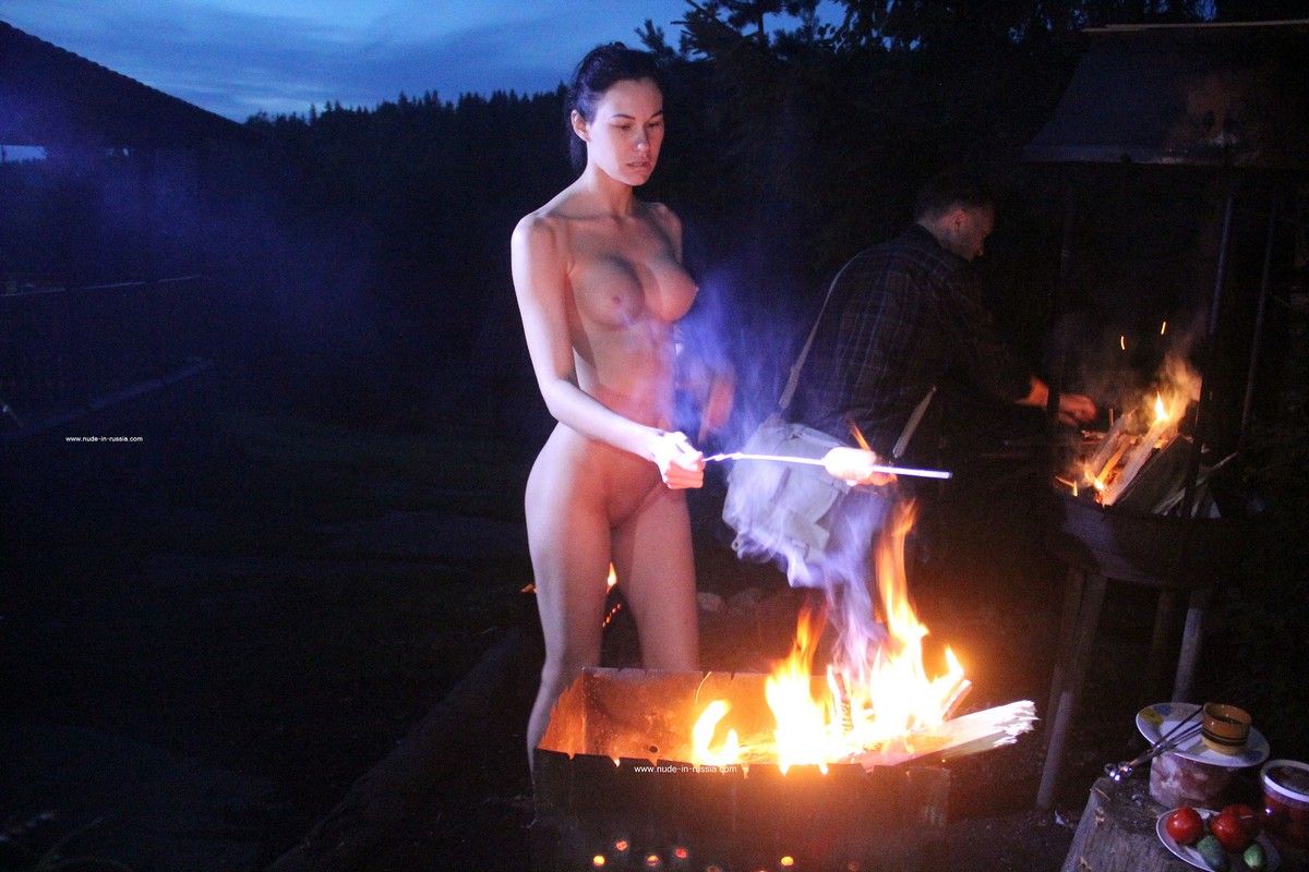 Naked brunette Nastia B cooks kebabs at the grill