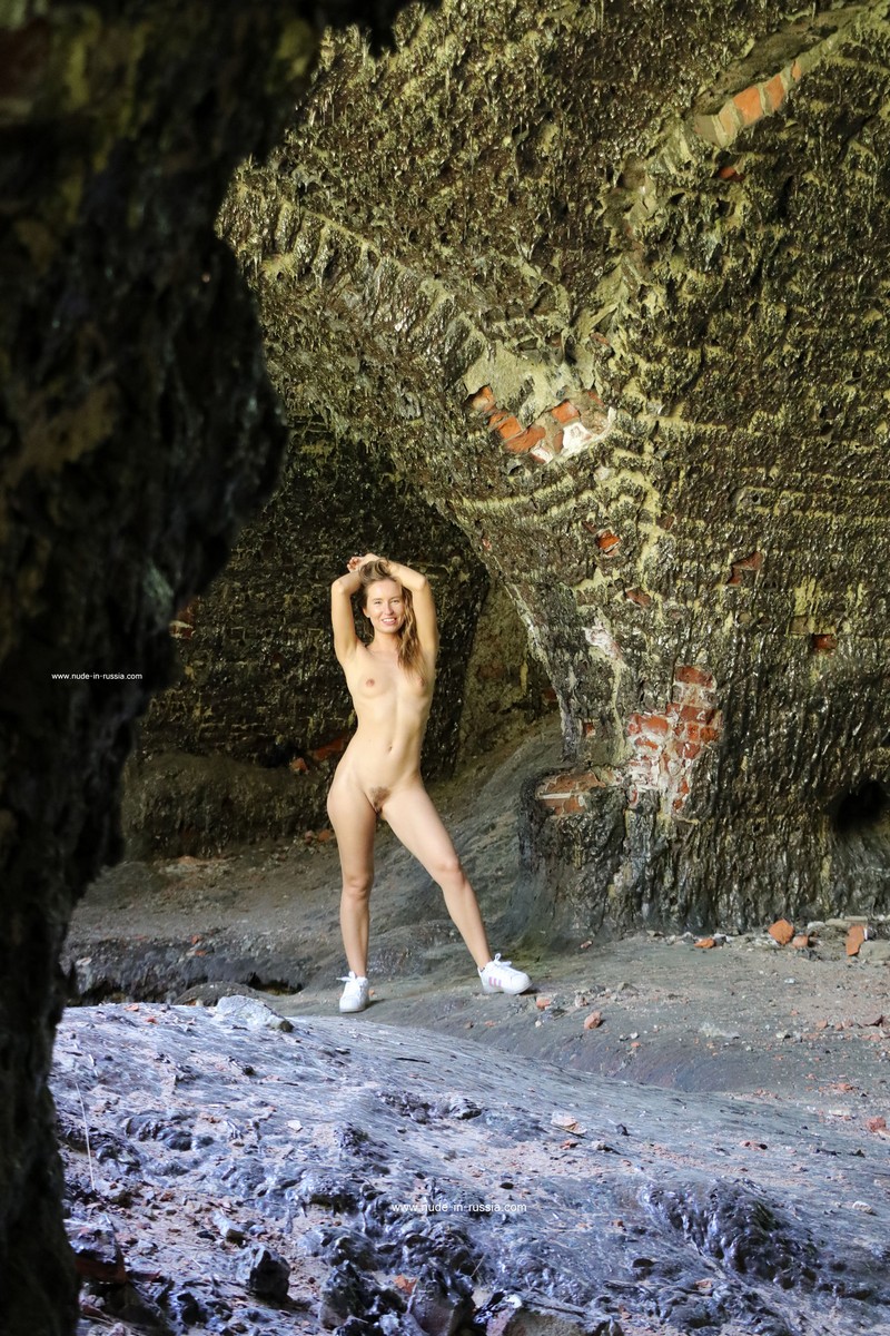 Naked girl Margarita S walks through the burnt old fort
