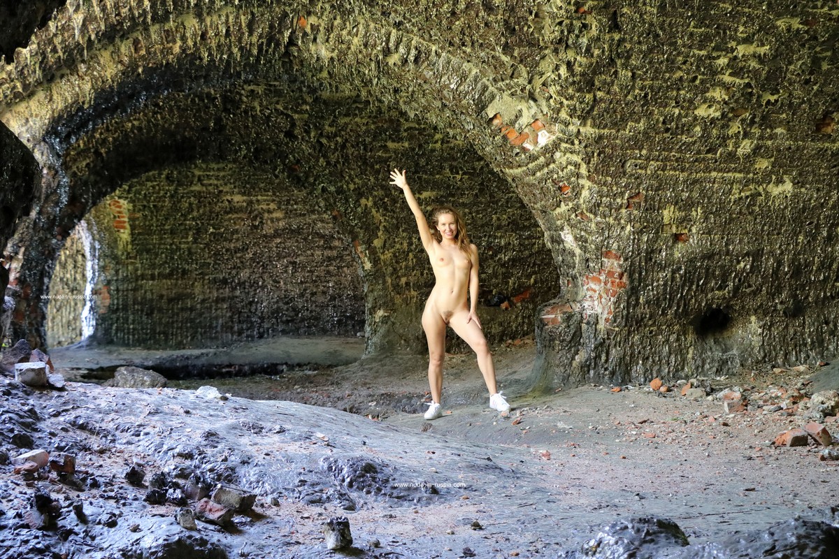 Naked girl Margarita S walks through the burnt old fort
