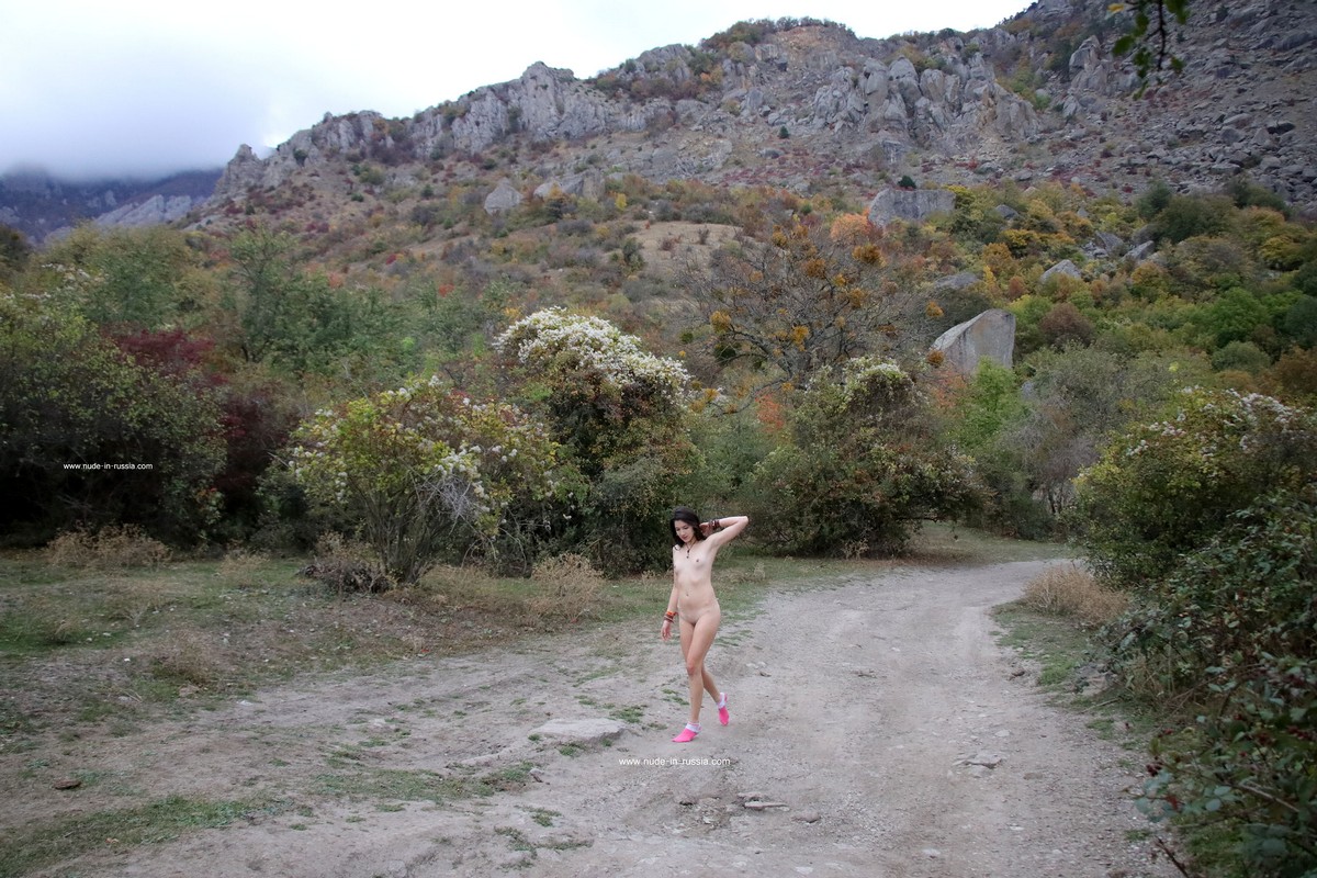 A cute girl Katja P in pink socks walks in the mountains of Crimea