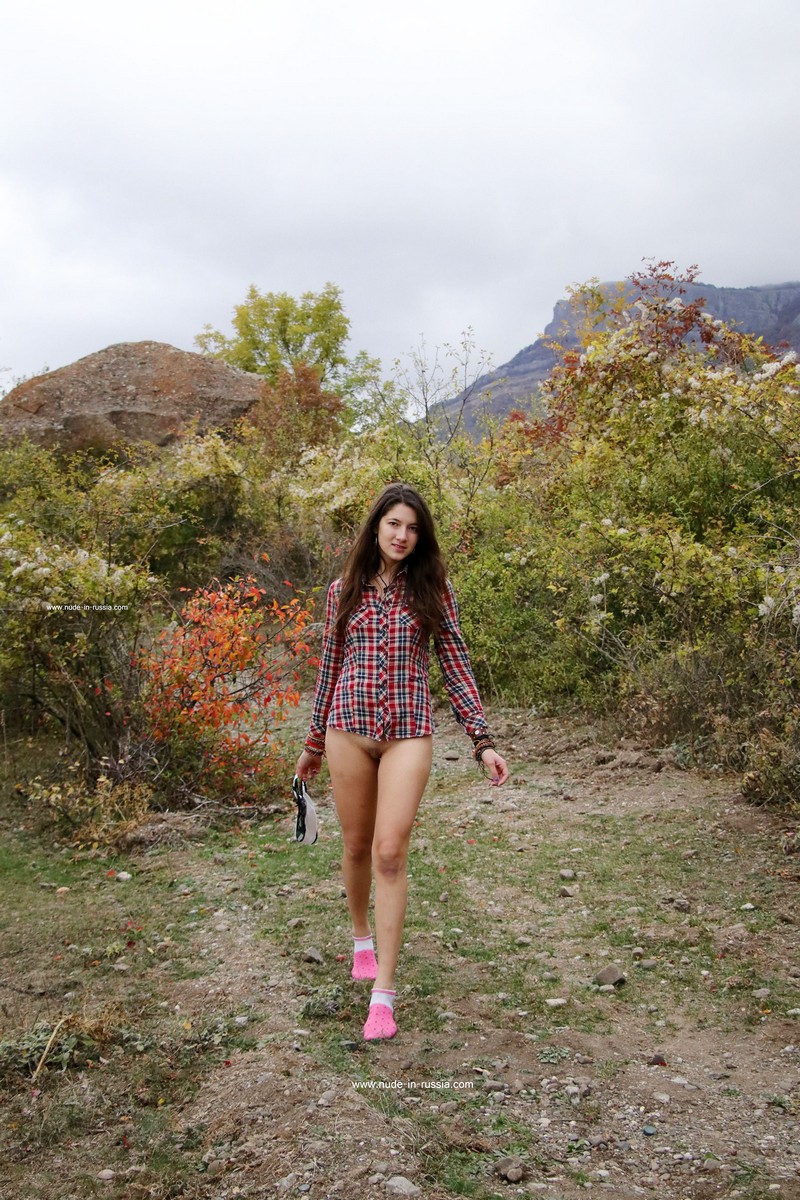 A cute girl Katja P in pink socks walks in the mountains of Crimea