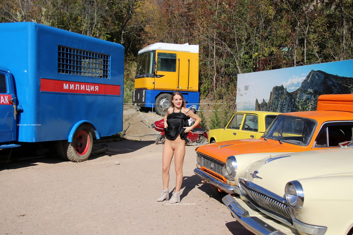 Beautiful Russian girl Vlada posing with old cars from movies