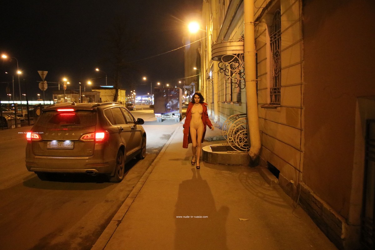A slender Russian girl Diana T shows her body on the night streets of St. Petersburg