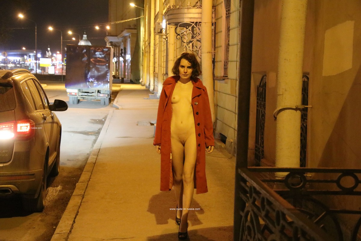 A slender Russian girl Diana T shows her body on the night streets of St. Petersburg