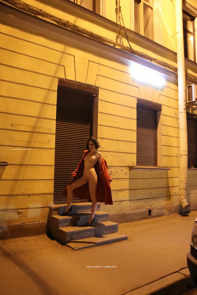 A slender Russian girl Diana T shows her body on the night streets of St. Petersburg