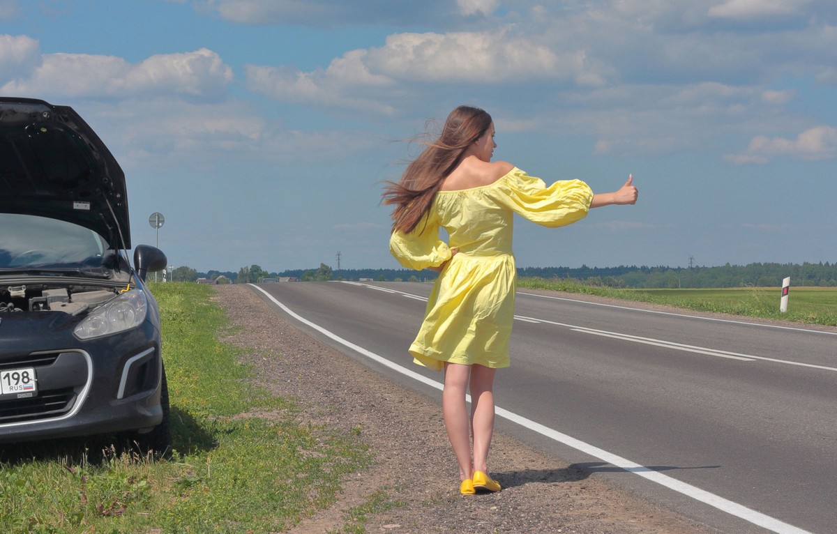 Naked girl Natalia tries to fix a car on the highway