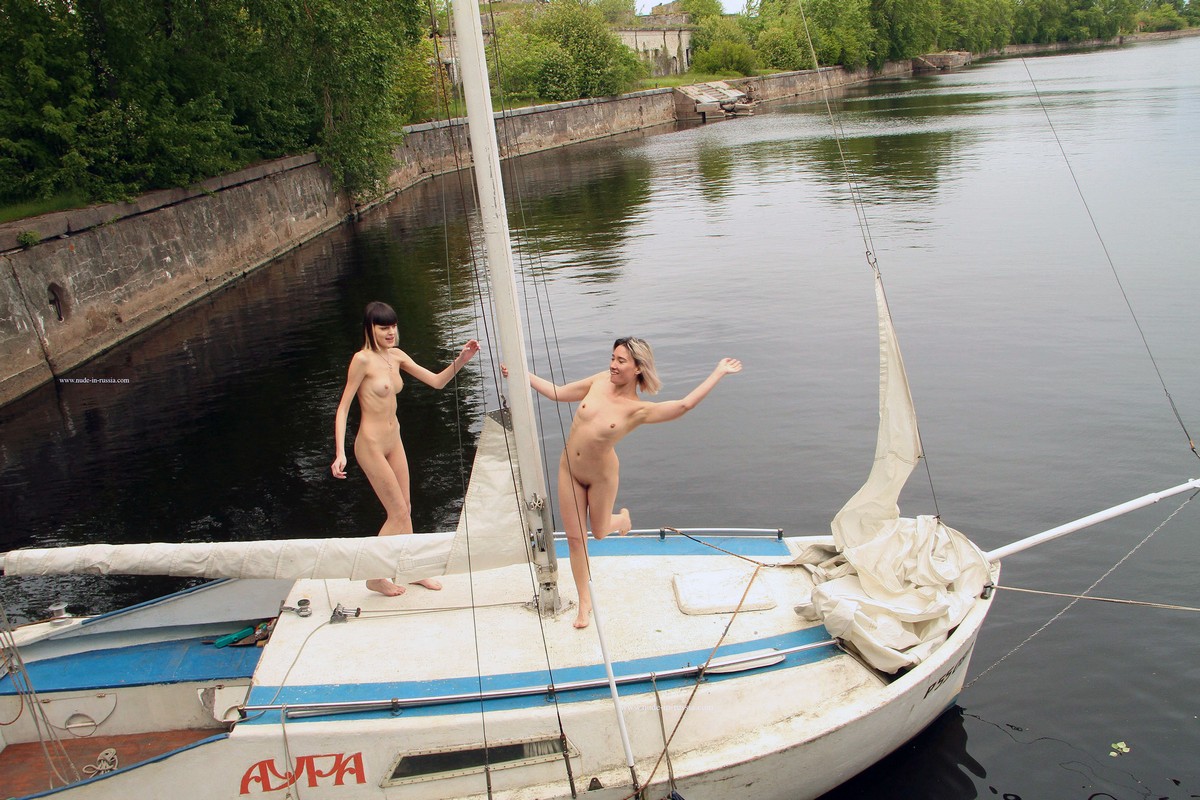 Two young girls undress on a yacht near the old fort