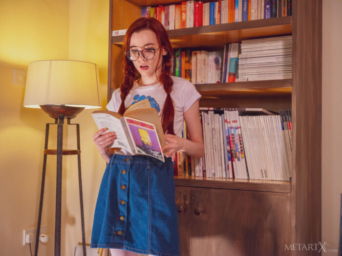 Gorgeous red haired Sherice opens a book by the bookshelf to read and decides to slip her finger inside her denim skirt and pleasure herself by the window instead.