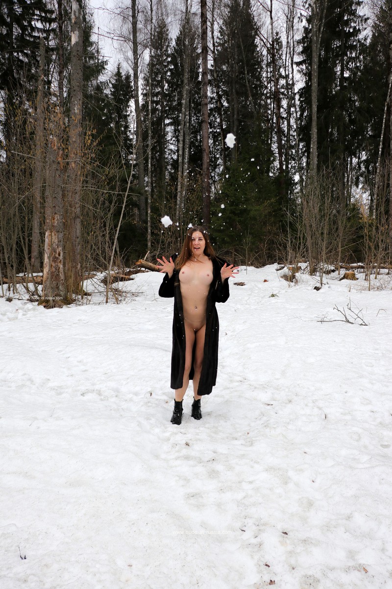 Young russian Paulina plays with a snow at forest