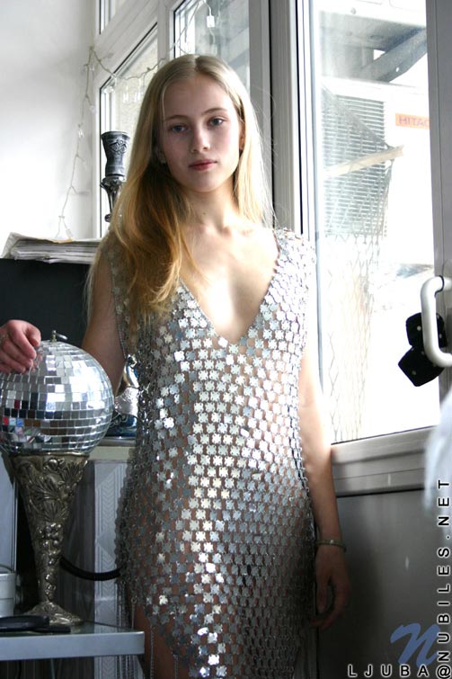 Slender blond teen hottie struts around in a metal dress you gotta see to believe