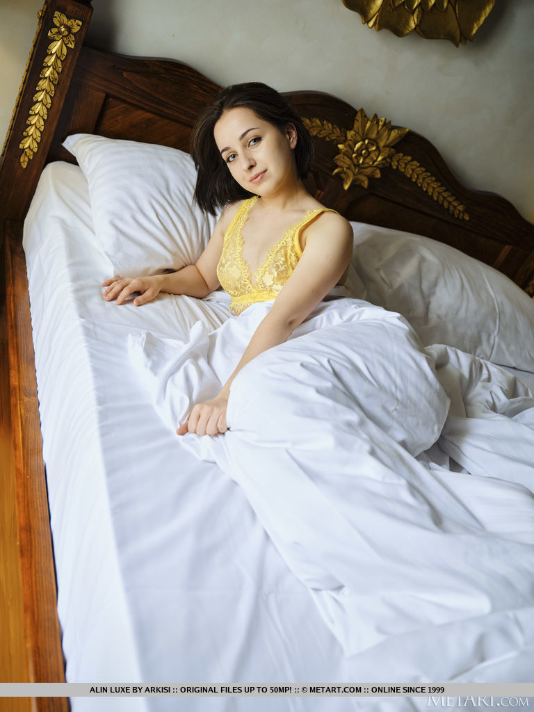 Gorgeous new model Alin Luxe charmingly pulls her yellow lace lingerie and flashes her perky sweet boobies and pinkish shaved coochie on the bed.