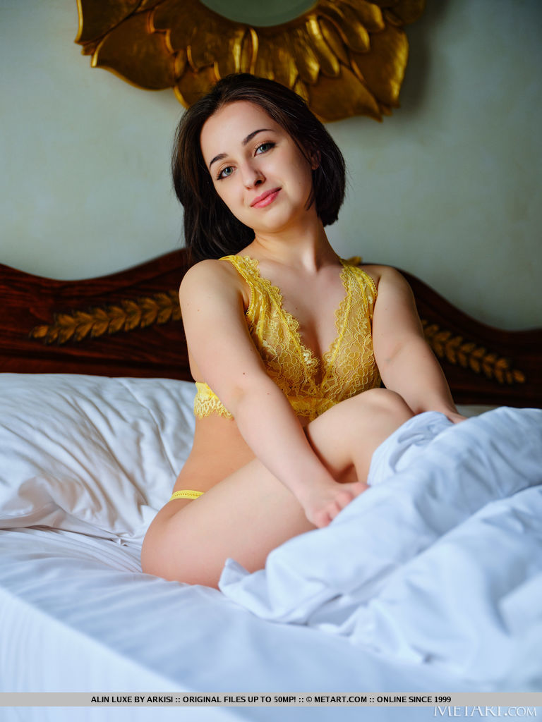 Gorgeous new model Alin Luxe charmingly pulls her yellow lace lingerie and flashes her perky sweet boobies and pinkish shaved coochie on the bed.