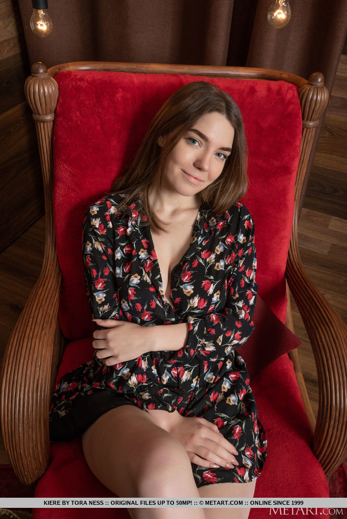 Kiere enticingly unbutton her romper and exposes her huge juicy melons and smooth cunt on the red chair.