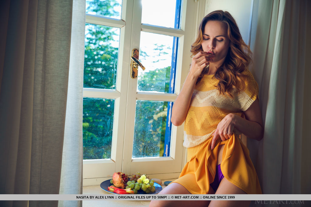 Nasita poses at the window as she pinch her nipples and rubs her pussy.