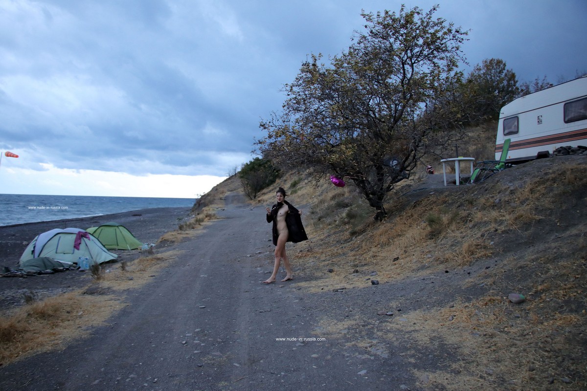 Russian long-haired teen Camille smokes at windy beach