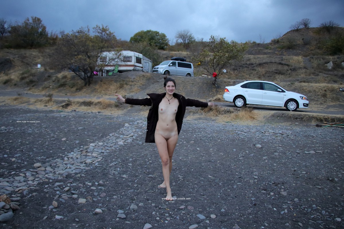 Russian long-haired teen Camille smokes at windy beach