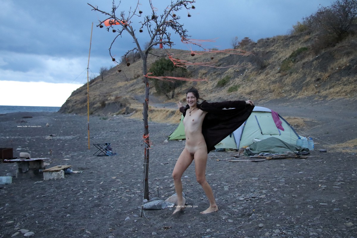 Russian long-haired teen Camille smokes at windy beach