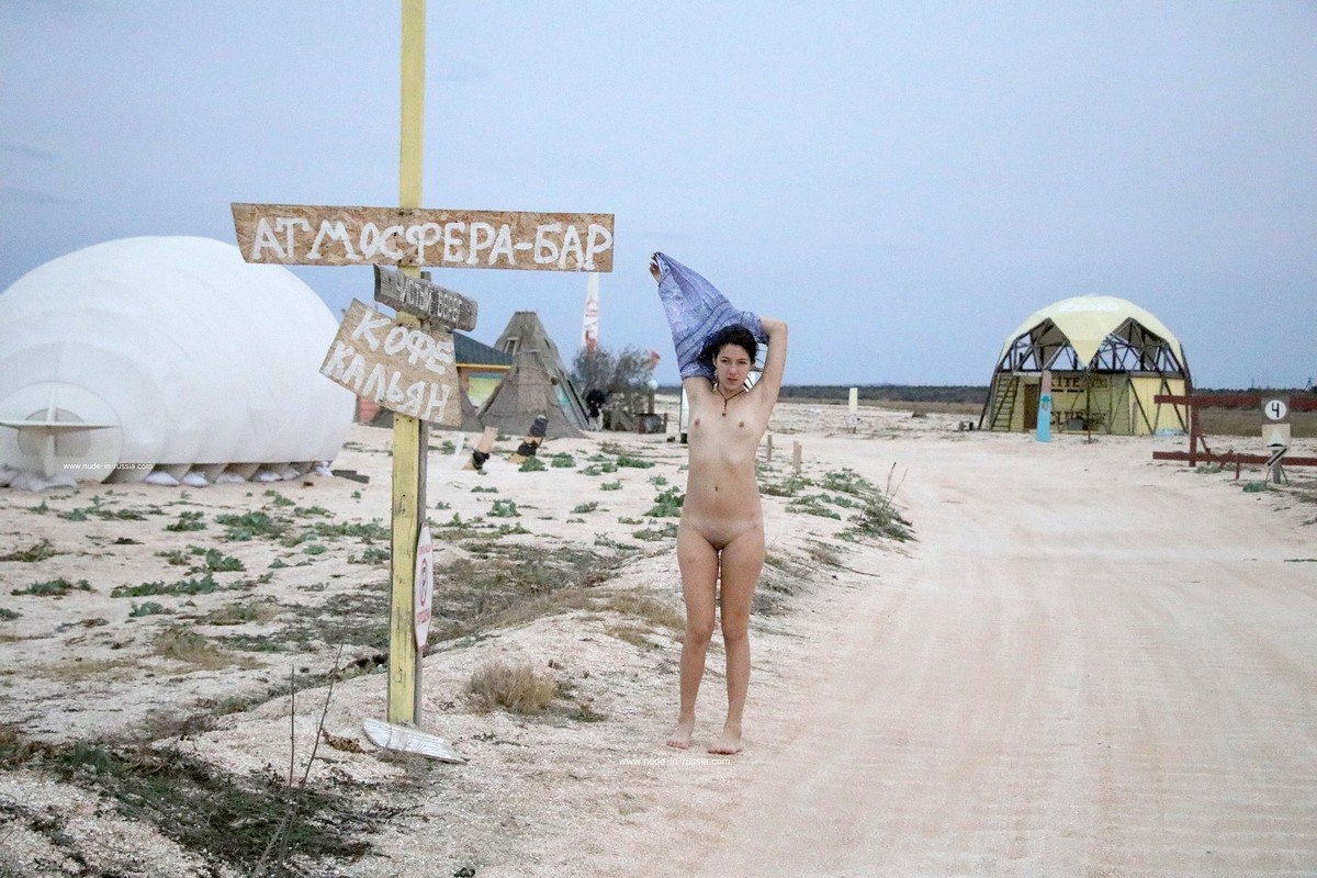 Two naked girls posing at sandy beach