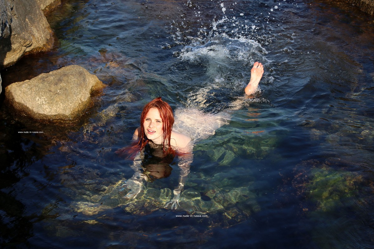 Beer-fueled men caught a beauty's photo shoot on the rocks