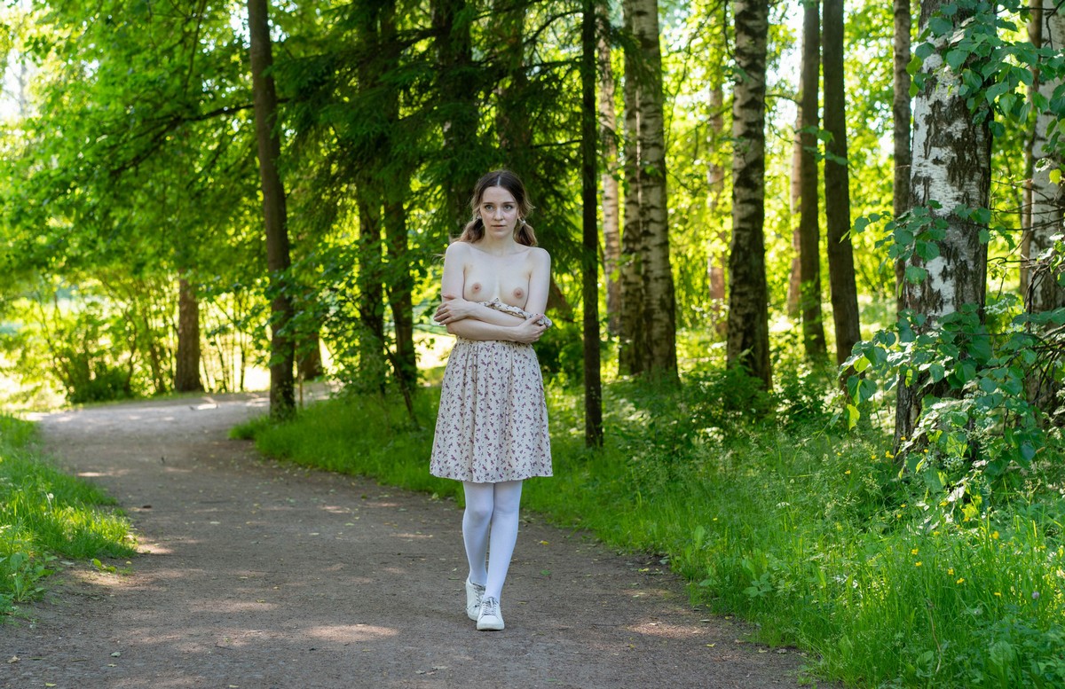 Cute girl Anna without clothes walking in the park