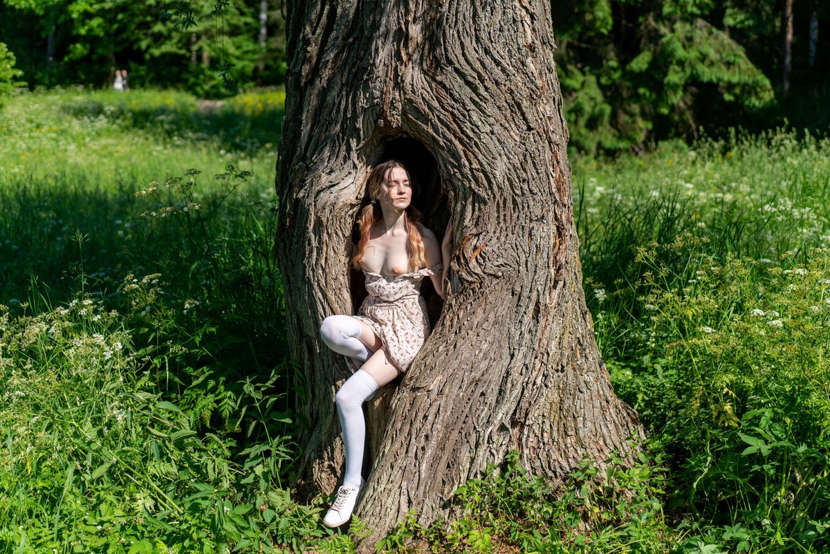 Cute girl Anna without clothes walking in the park