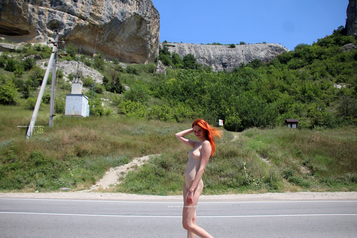 Redhead beauty Angel Rai walks naked on the highway