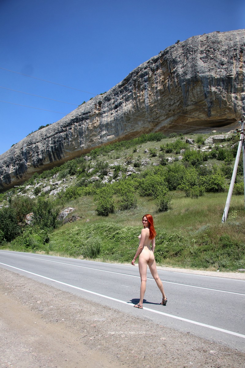 Redhead beauty Angel Rai walks naked on the highway