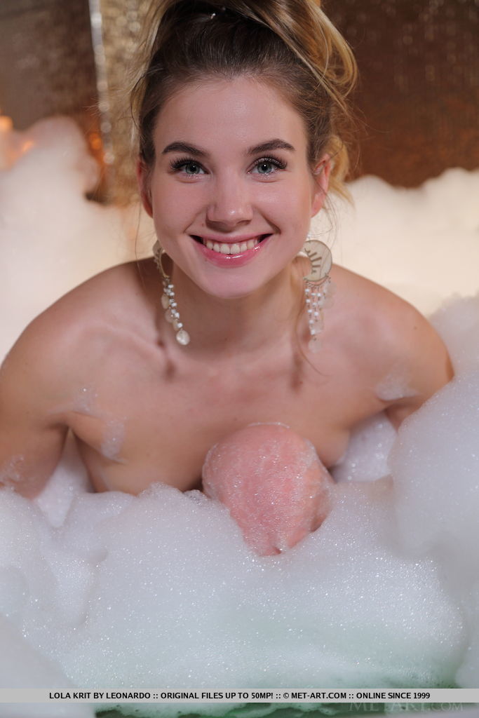 Lola Krit playfully poses on the bathtub as she take a bubble bath.