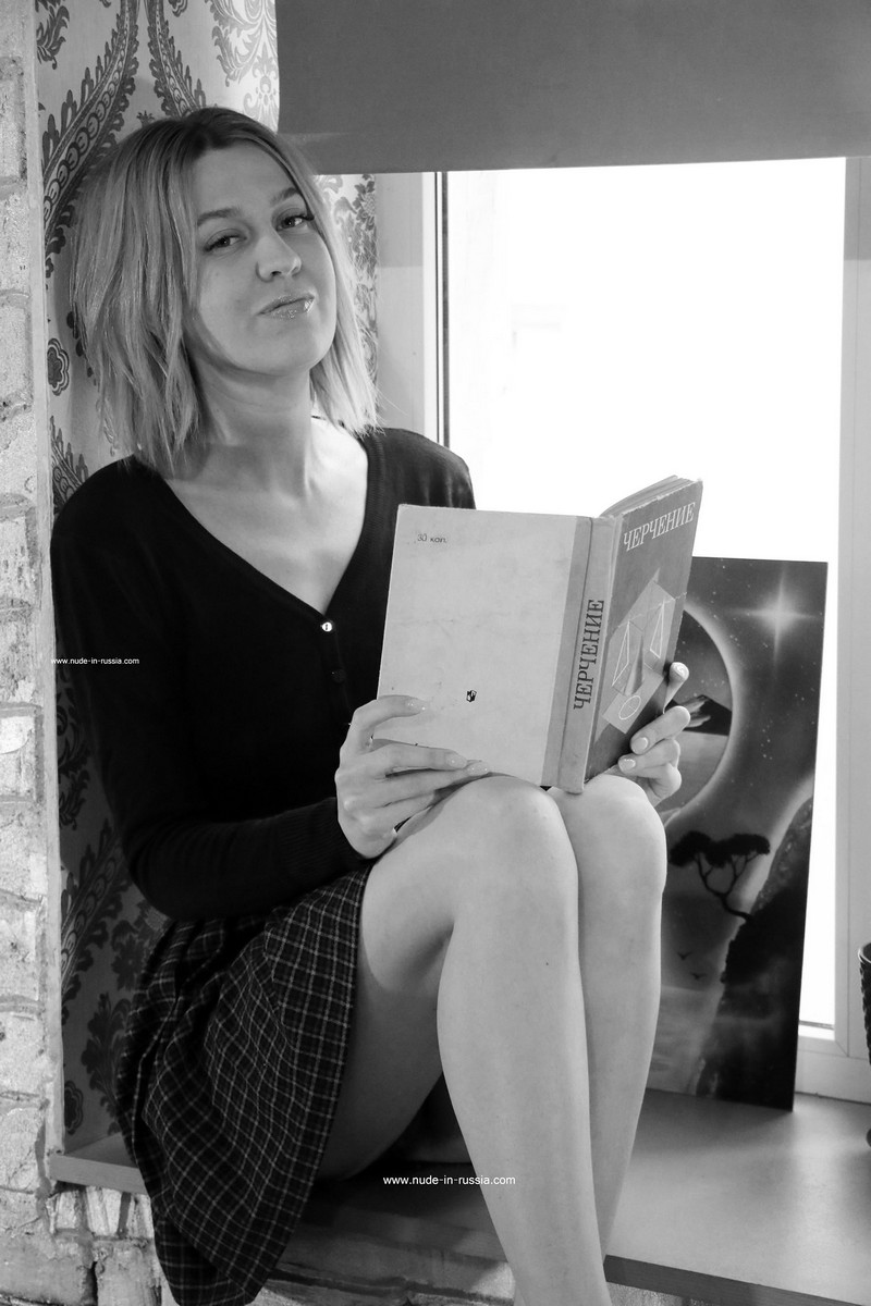 Smiling blonde Evelin with a Soviet textbook