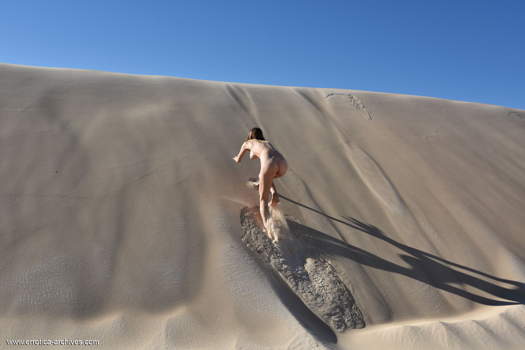 Maxa was alluring to present her heavenly body while the sand touches her skin.