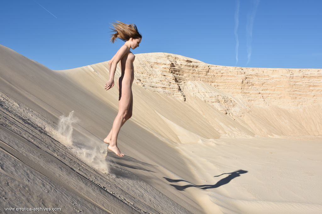 Maxa was alluring to present her heavenly body while the sand touches her skin.