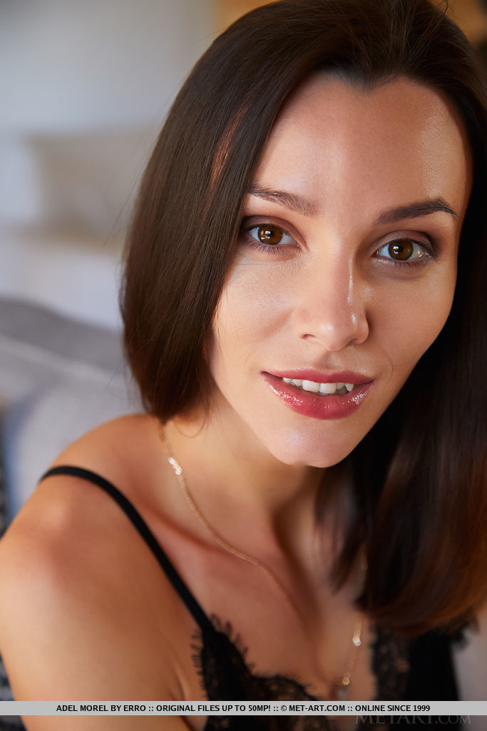 Adel Morel strips her sexy, black lingerie on the couch, baring her creamy pussy.